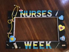 a wooden frame with the words nurses week written on it and various medical items around it