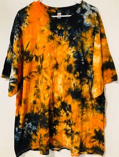 Adult 3XL Gravity ice dye free style scrunch tie dye. This orange and black Halloween shirt is much brighter in person than in pictures. There are hidden pictures including a skull (or that's what it looks like to us). One of the first shirts I did and still one of my favorites. This is a one of a kind shirt and you get the exact one you see pictured. This shirt is handmade by me using the ice dye technique. Gildan 100% cotton, heavy fabric that is less likely to shrink over time. I recommend wa Orange And Black Tie Dye, Scrunch Tie Dye, Fall Ties, Tie Dye Crafts, Plus Size Shirt, Ice Dye, Hidden Pictures, Halloween Orange, Colors Orange