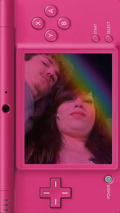 a pink nintendo wii game system with an image of a man and woman on the screen