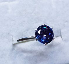 Round Cut Tanzanite Birthstone Ring With Prong Setting, Tanzanite Birthstone Ring With Prong Setting, Silver Tanzanite Round Rings, Blue Brilliant Cut Tanzanite Ring, Brilliant Cut Round Tanzanite Gemstones, Unusual Rings, Star Ring, Charm Rings, Blue Band