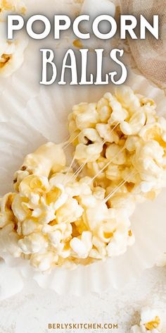 popcorn balls on a paper plate with the words popcorn balls written in white over it