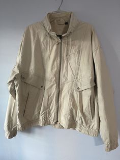 Mens vintage 1990s beige Members Only jacket. Tag size XL.  Arm pit to arm pit = 28 Length = 26 Condition = few light small stains on front  Not sure of material. Probably polyester cotton mix. Beige Cotton Windbreaker For Streetwear, Beige Cotton Windbreaker With Pockets, Vintage Oversized Cream Outerwear, Vintage Beige Outerwear For Streetwear, Members Only Jacket, Mens Vintage, Members Only, Jacket Coat, Vintage Men