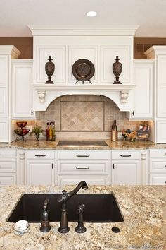 a large kitchen with white cabinets and granite counter tops is pictured in this image from the front view