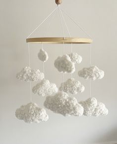 a crocheted cloud mobile hanging from a ceiling