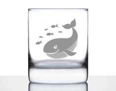 a glass with a whale and fish design on it