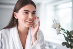 Stock Image: Portrait of pleased young lady touching cheek with hand. She putting cream on face skin indoor Winter Moisturizer, Make Up Primer, Natural Oils For Skin, Beauty Regime, Beauty Awards, Oils For Skin, Belleza Natural, Face Serum, Radiant Skin