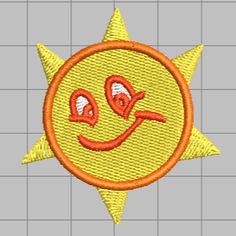 an embroidered patch with the shape of a smiling face in orange and yellow, on a gray background