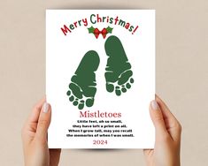 two hands holding up a christmas card with the words mistetos written on it