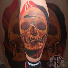 a man with a skull tattoo on his leg