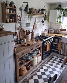 a kitchen filled with lots of pots and pans next to a stove top oven