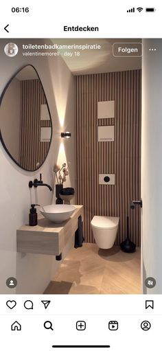 a bathroom with two sinks and a large round mirror above the sink in front of it