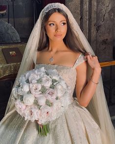 a woman in a wedding dress holding a bouquet