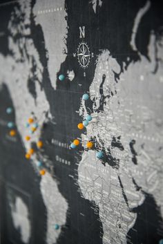 an image of a map with pins in the shape of a world and compass on it