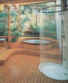 a wooden deck with a hot tub in the middle and potted plants on either side