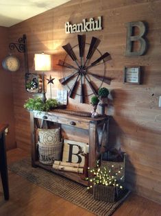 a living room with wood paneling and a windmill on the wall next to it