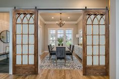 a dining room with wooden floors and glass doors