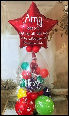 a christmas ornament with balloons in the shape of a star and saying,'santas find me all this way to be with you '