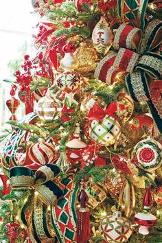 the christmas tree is decorated with red, green and gold ornaments