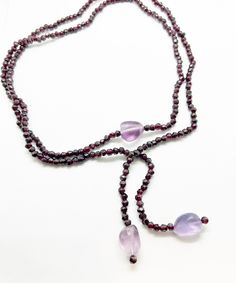 "Lariat garnet necklace with chunky amethyst beads.  Versatile piece to wrap and tie around your neck or waist or wrist.  43\" in long" Adjustable Lariat Jewelry With Gemstone Beads, Lariat Beaded Necklaces With Natural Stones For Jewelry Making, Adjustable Lariat Crystal Necklace With Gemstone Beads, Spiritual Style Long Lariat Necklace With Gemstone Beads, Spiritual Gemstone Beads Lariat Necklace, Adjustable Lariat Necklace With Gemstone Beads, Lariat Necklace With Round Beads As Gift, Bohemian Lariat Necklace With Gemstone, Gift Lariat Long Necklace With Single Strand