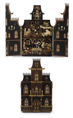 an image of a doll house made out of wood and painted black with gold accents