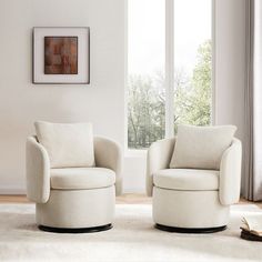 two white chairs sitting in front of a window