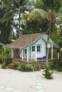 a small house with a hammock on the roof and steps leading up to it