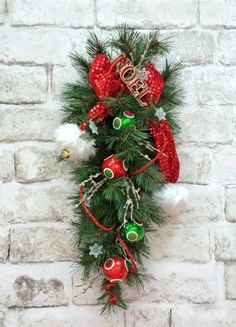 a christmas wreath hanging on the side of a brick wall