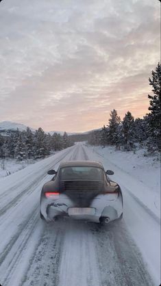 a car driving down a snow covered road