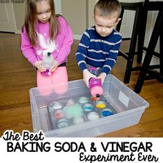 two children playing with baking soda and vinegar experiment