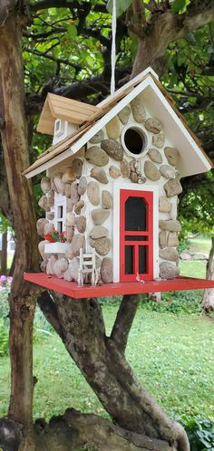 a bird house is hanging from a tree