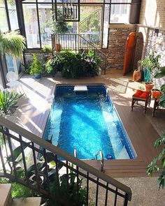 an indoor swimming pool in the middle of a house