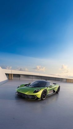 a green sports car parked on top of a roof