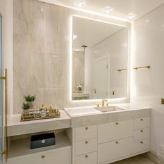 a bathroom with two sinks and a large mirror over it's counter top area