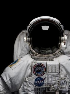 an astronaut's space suit with patches on it