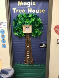 a door decorated like a tree with a house on it