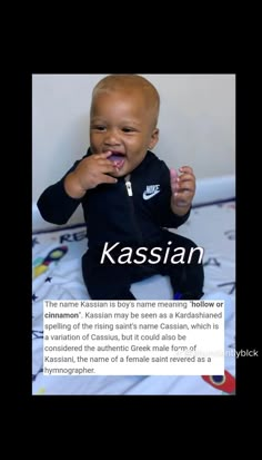 a baby sitting on top of a bed with the caption kassin