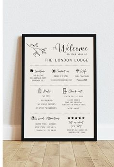 a welcome sign hanging on the wall in front of a wooden floor and white walls