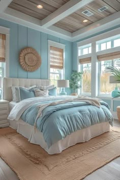 a bedroom with blue walls and white bedding in the center, along with two windows