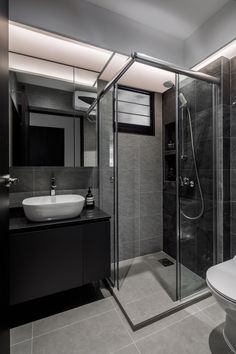 a black and white bathroom with a glass shower