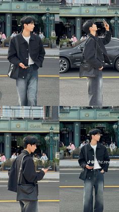 the man is talking on his cell phone while standing in front of a building with cars