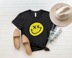 Melted Smiley Face T Shirt, Smile Face T-Shirt, Happy Face Shirt, Smiling Emoji Shirt, Retro Smile Checkered, Positive Vibes Tee, Funny Shirts * If front and back printing will be done, an extra fee is required for back printing. *  TO ADD CUSTOM TEXT ON THE BACK OF THE T-SHIRT, PLEASE CLICK THE LINK BELOW AND ADD TO CART https://www.etsy.com/listing/1171873978/purchase-to-add-custom-text-for-the-back?click_key=60a3b028f8ce38a2bb0bc3aaf004e622d7bc8ee2%3A1171873978&click_sum=3699001f&ref=shop_hom Black Smiley Face Crew Neck Top, Black Crew Neck Top With Smiley Face, Black Smiley Face Crew Neck T-shirt, Black Crew Neck T-shirt With Smiley Face, Funny Smiley Face T-shirt For Summer, Funny Smiley Face Crew Neck Tops, Funny Smiley Face Summer T-shirt, Melted Happy Face, Smiley Face T Shirt