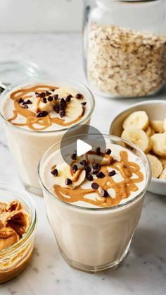 three glasses filled with desserts on top of a white marble counter topped with bananas and chocolate chips