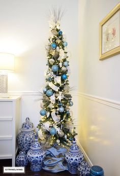 a decorated christmas tree with blue and white ornaments