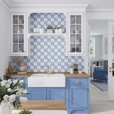 a blue and white kitchen with wooden counter tops, cabinets, and shelves on the wall