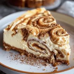 a piece of cake on a plate with cinnamon roll toppings and powdered sugar