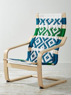 a blue and white chair sitting on top of a hard wood floor