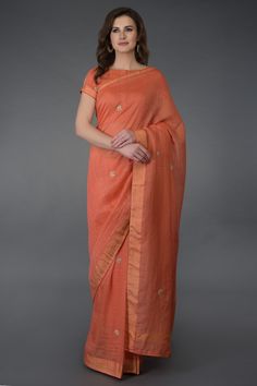 Coral hued saree with all over checkered texture and placement zardosi motifs. Comes with matching blouse.
Components: 2
Fabric: Kota linen, Cotton, Chanderi
Neckline: Bateau
Sleeve Length: Short
Color: Coral
Zardosi embroidery
Piping detail
Closure: Front hook buttons - Aza Fashions Coral Saree, Formal Saree, Indian Sari Dress, Coral Blouse, Indian Saree Blouse, Simple Sarees, Embroidered Saree, Living Coral, Indian Bridal Wear