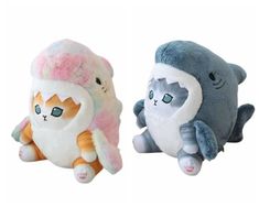 two stuffed animals sitting next to each other in the shape of an elephant and cat