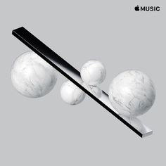 an apple music device with marble balls on it and a black stick sticking out of the top