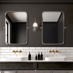 a bathroom with two sinks and mirrors on the wall